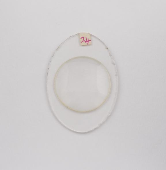 Oval white 'new-system' cemented plano-convex cataract lens.