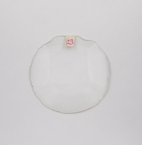 Round white meniscus convex cataract lens.