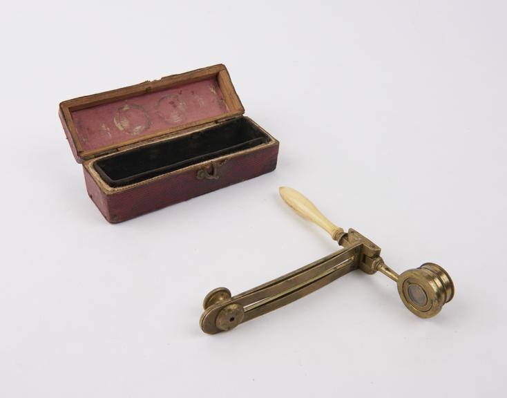 Folding hand microscope in red leather box with hook to close