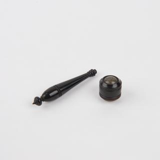 Lens set in tortoiseshell cylinder
