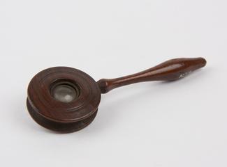 Lens in cylinder of walnut wood