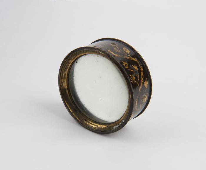 Hand magnifier, with ornate pattern on mounting, English