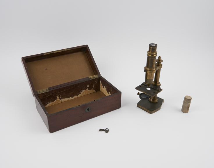 Small compound monocular microscope in case, by Nachet and Son