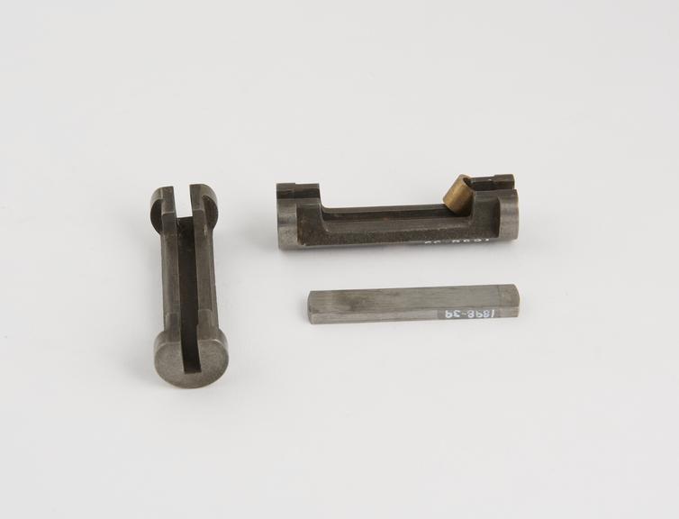 Four metal components associated with the Single cylinder