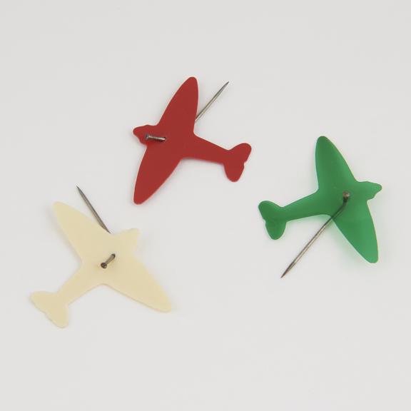 Three celluloid tie-pins of aeroplane: green, white, red