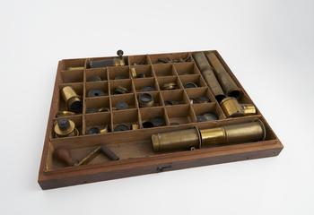 Box containing eyepieces and other accessories for refracting telescope by Wray.