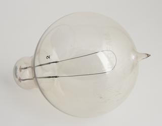 One of four early Swan bamboo filament lamps rated: (a) 65v