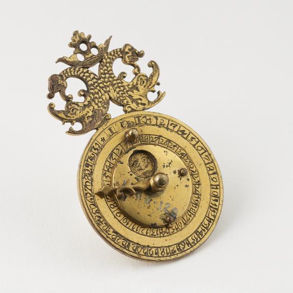 Perpetual calendar, gilt metal, 2? x 9/16-inches, Germany