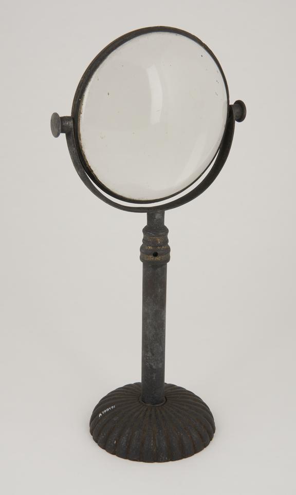 Condenser lens on telescoping stand, set on fluted base