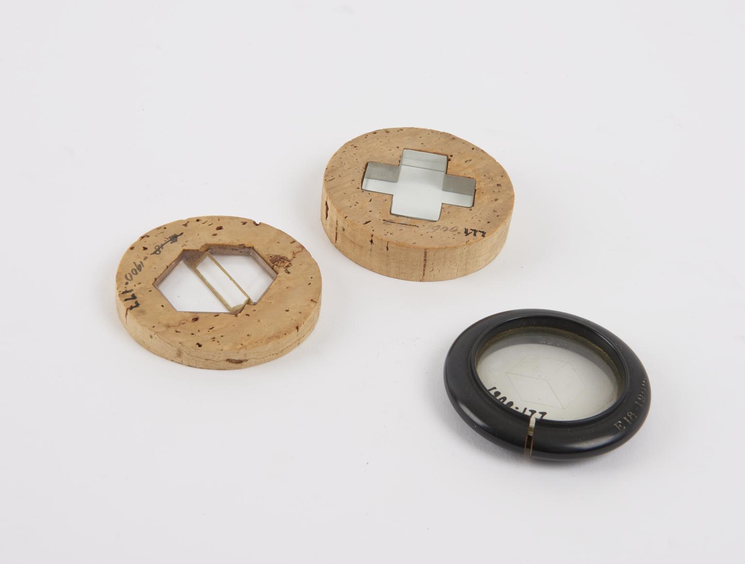 Two cork and one wood framed polari-scope lenses