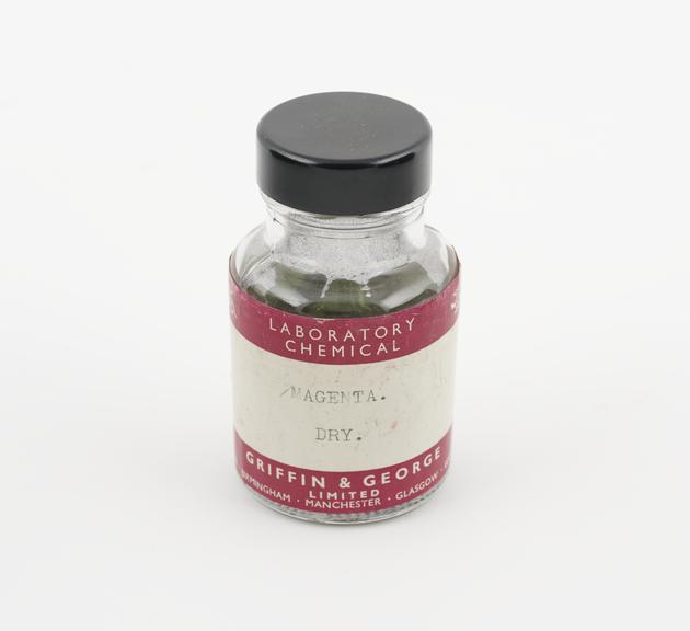 A bottle containing about  20gms of magenta dye in lumps