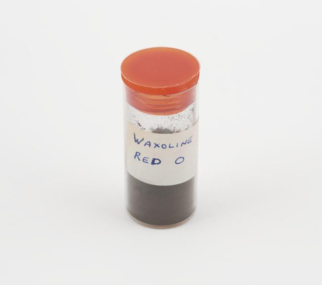 A vial containing 5gm of biological stain, waxoline red O.