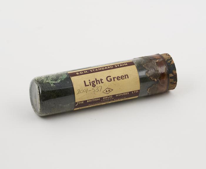 A glass vial containing 25gms of biological stain, Light Green