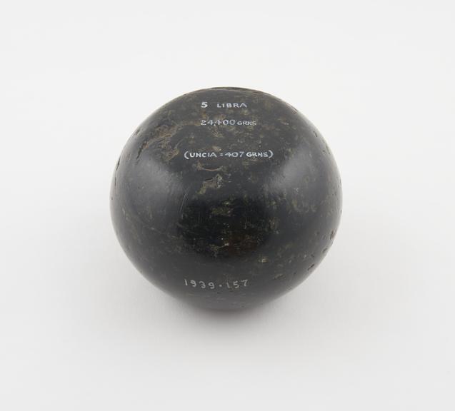 One of 15 Roman weights, cheese-shaped, polished black basalt