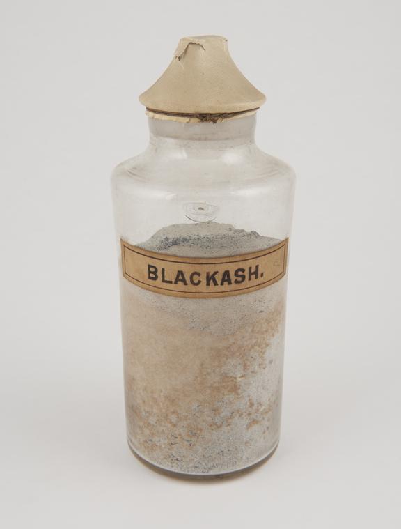 Bottle containing black ash.