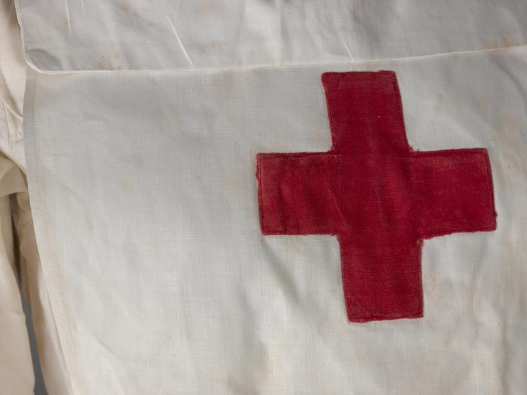 White cotton apron with a red cross