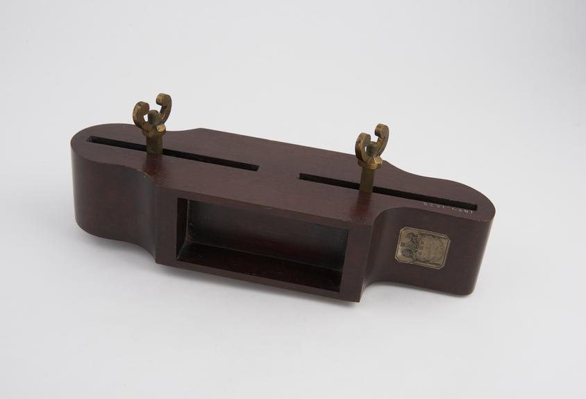 Fixture to hold cavity for clay, in experiments on the destruction of forces