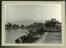 Mounted photographic prints of buildings next to a river