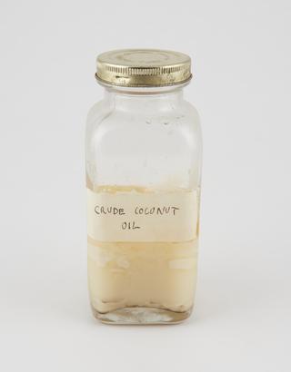 Specimen bottle containing coconut oil