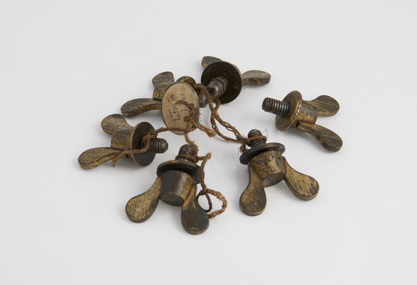 Six steel screws with brass butterfly heads and washers