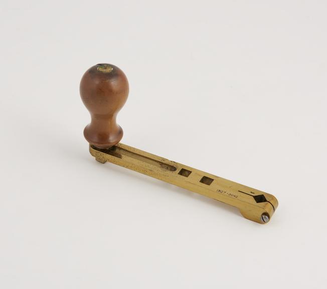 Adjustable brass crank, with three square holes, wooden handle