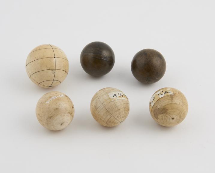 Two brass and four ivory spheres