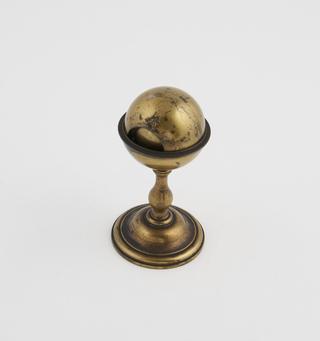 A Single Sphere Held in a Cup Stand.