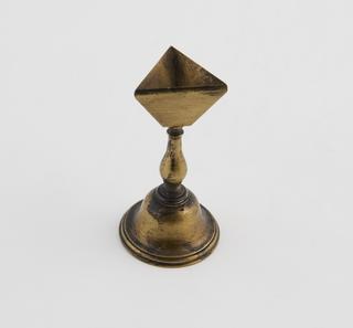 A Single Hollow Inverted Tetrahedron on a Stand.