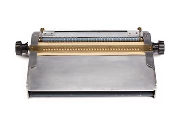 Positive Braille frame with two hand punches and rule for line drawing made by Sydney Smith