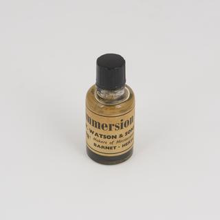 Bottle full of immersion oil supplied by W. Watson and Sons Ltd.