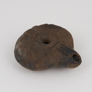 Graeco-Roman Egyptian earthenware wick spout lamp with corn\wreath motif on upper surface