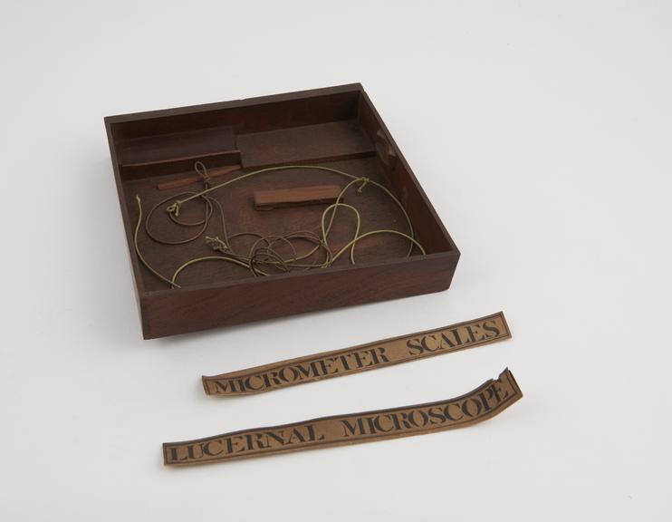 Drawer containing two labels and two lengths of string