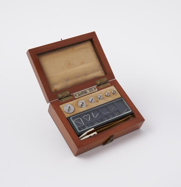 Mahogany box containing a set of white metal micro weights to