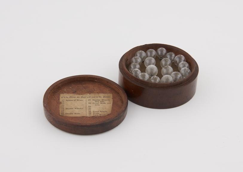 Round Mahogany Box, containing 18 spirit bubbles