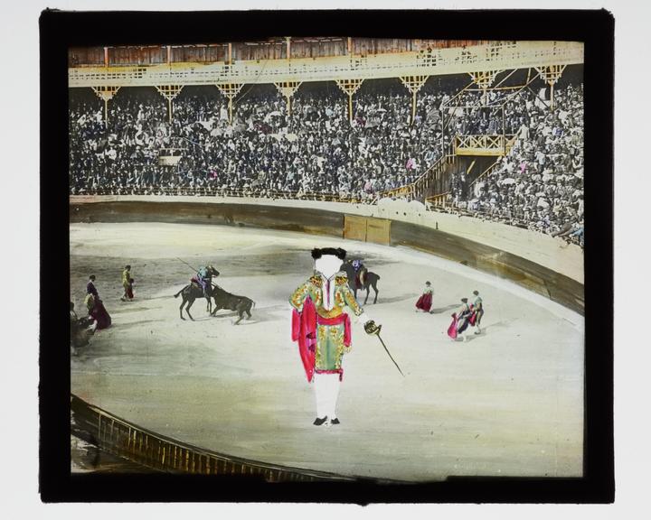 Magic lantern pose slide showing a bullfighter in an arena (Magic lantern pose slide)