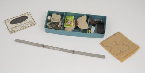 Tupperware box containing sewing machine accessories