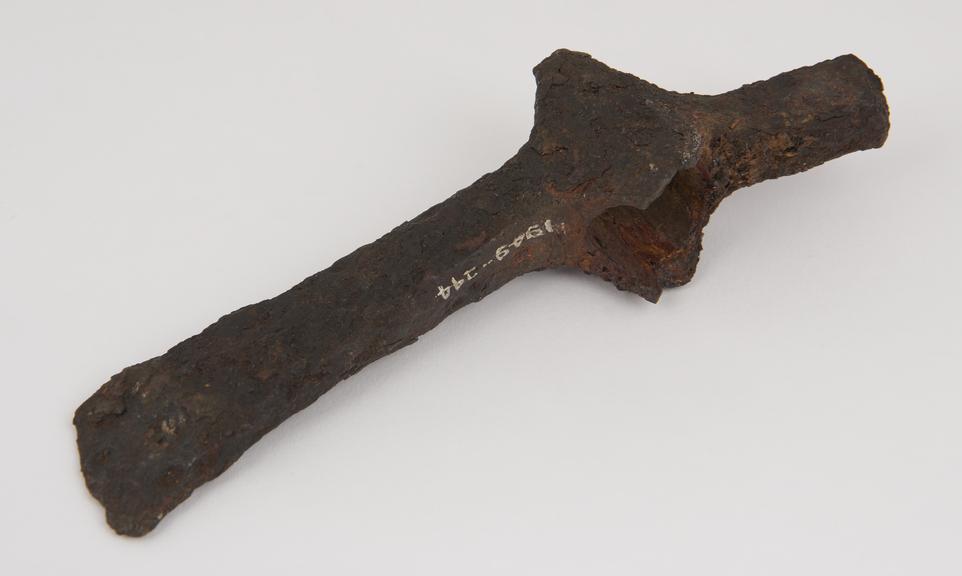 Socketed iron axe with hammer back and extended socket sides