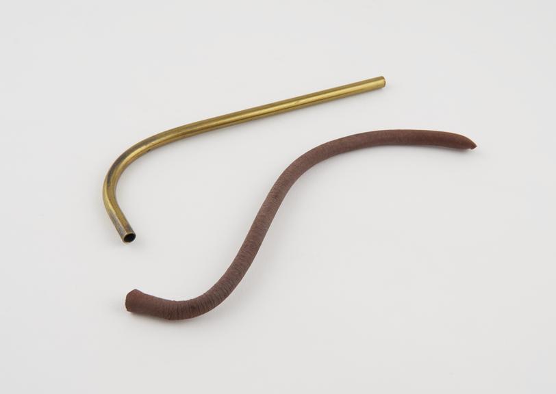 L-shaped brass tube and piece of red rubber tubing, by A