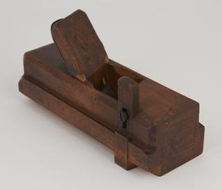 Wooden carpenter's wedge.