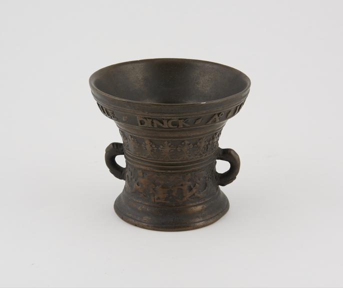 Bronze mortar, with two handles, decorated with an inscription