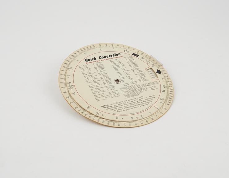 Circular slide rule, cardboard with plastic cursor arm