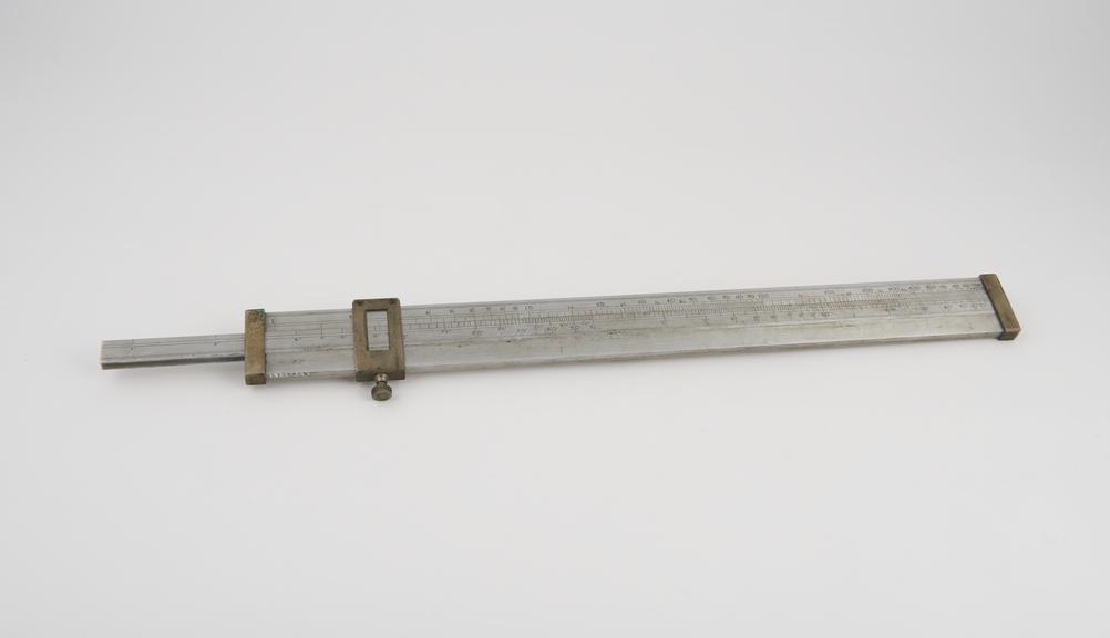 Artillery slide rule with cursor for range-finding, metal