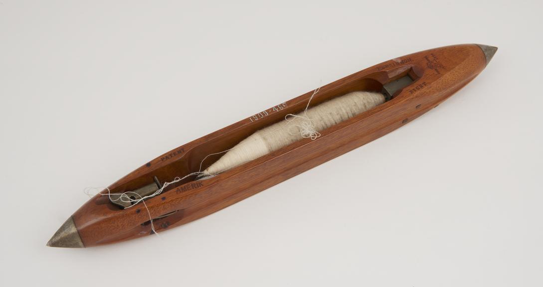 Weaver's shuttle with thread