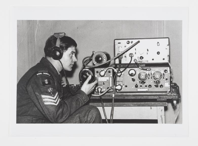 Silver gelatin photograph showing a young soldier sitting at a