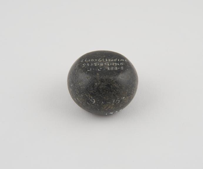 One of 15 Roman weights, cheese-shaped, polished black basalt