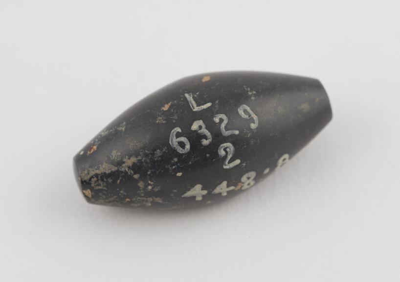 One of 3 black haematite Syrian weights, barrel shaped