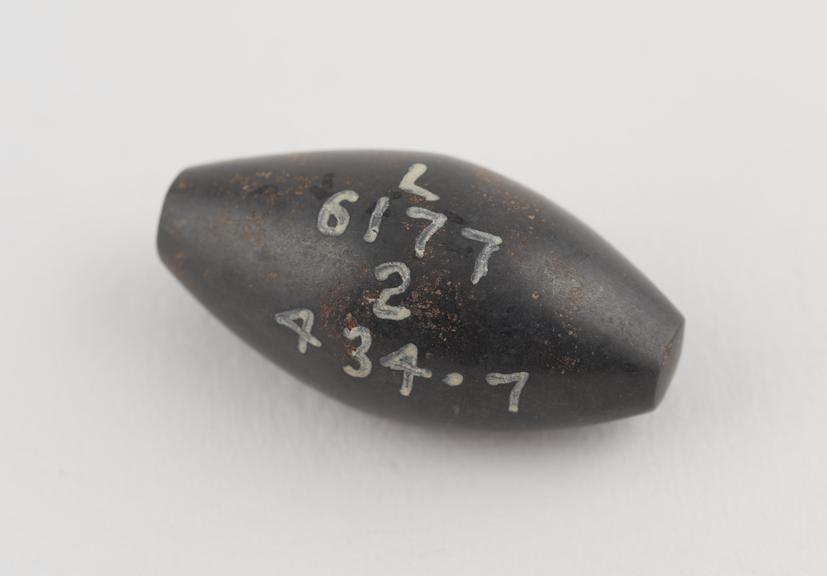 One of 3 black haematite Syrian weights, barrel shaped