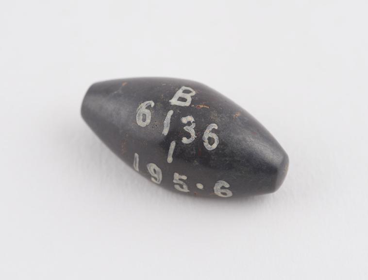 One of 6 black haematite Syrian weights, barrel shaped