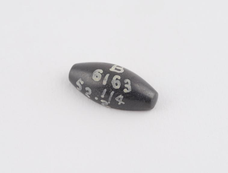 One of 6 black haematite Syrian weights, barrel shaped