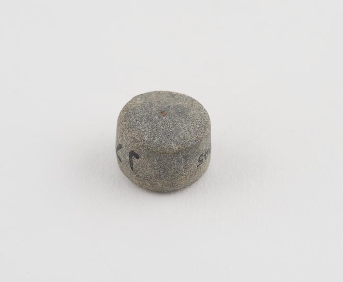 One grey limestone Syrian weight, flat cylindrical shape